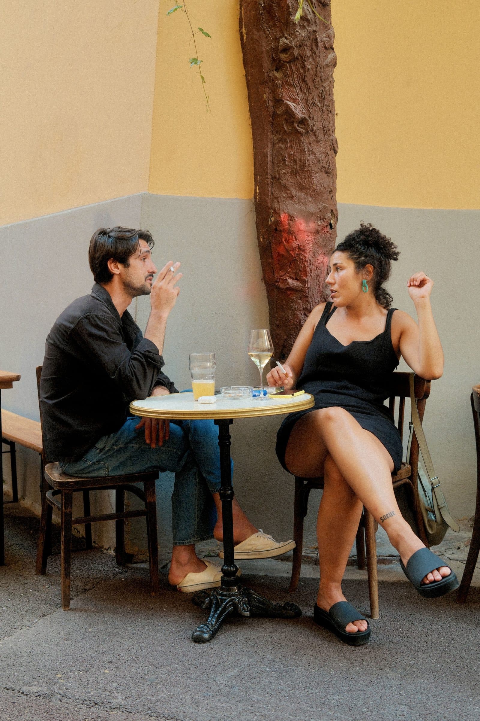 A couple deep in conversation at a small cafe table