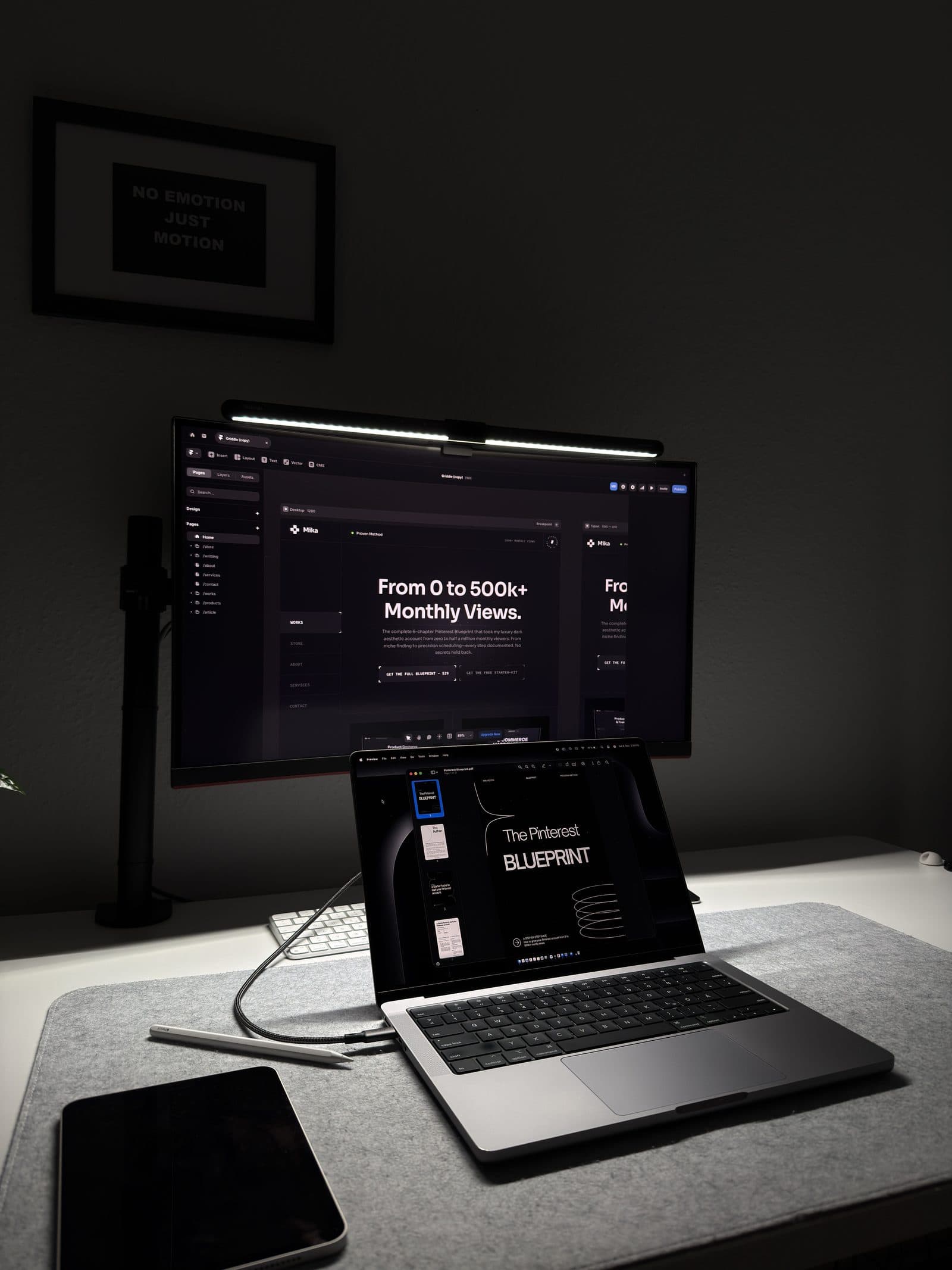 A phone showing apps on a desk beside a laptop