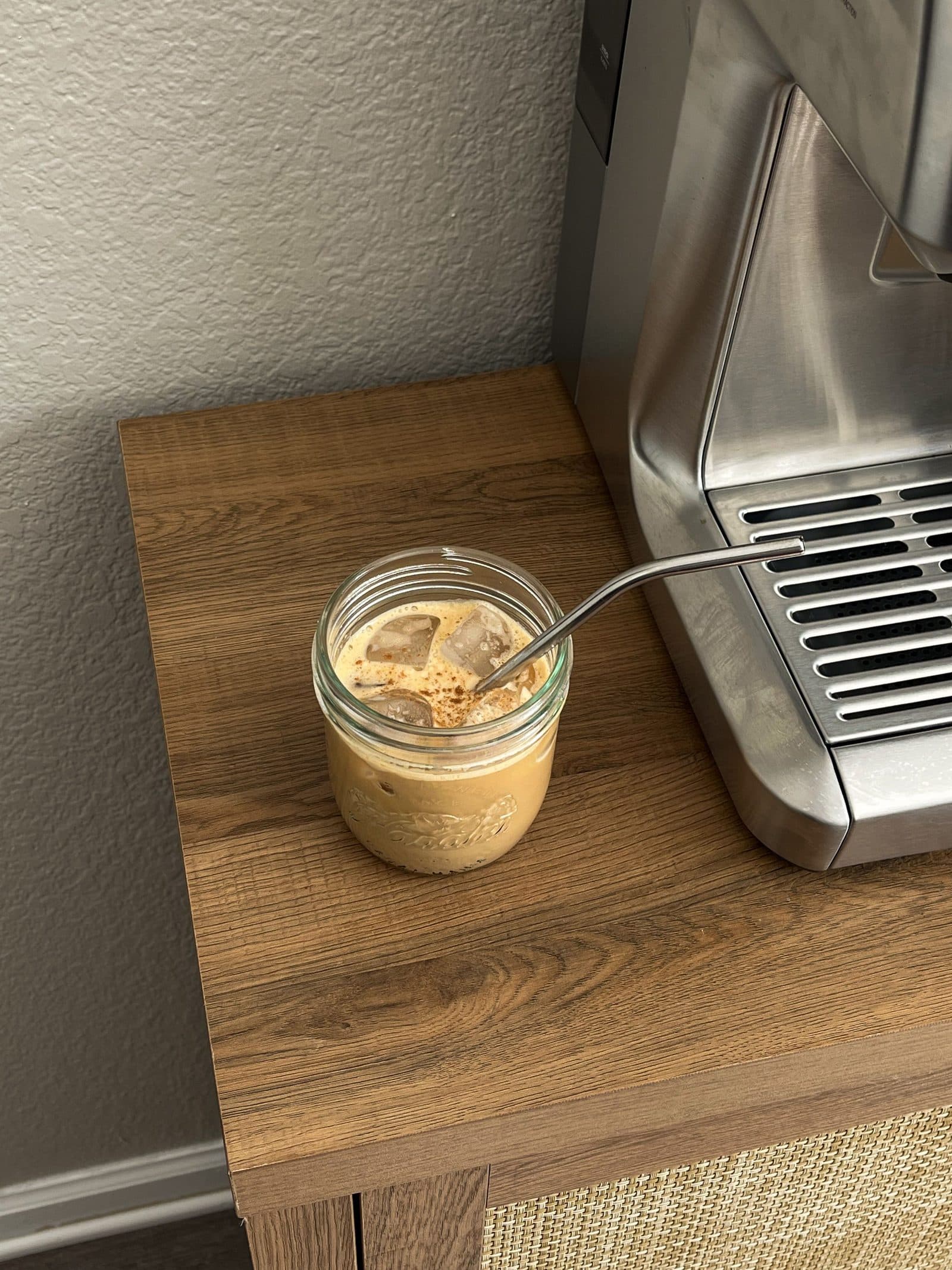 A homemade iced latte on a kitchen counter in morning light