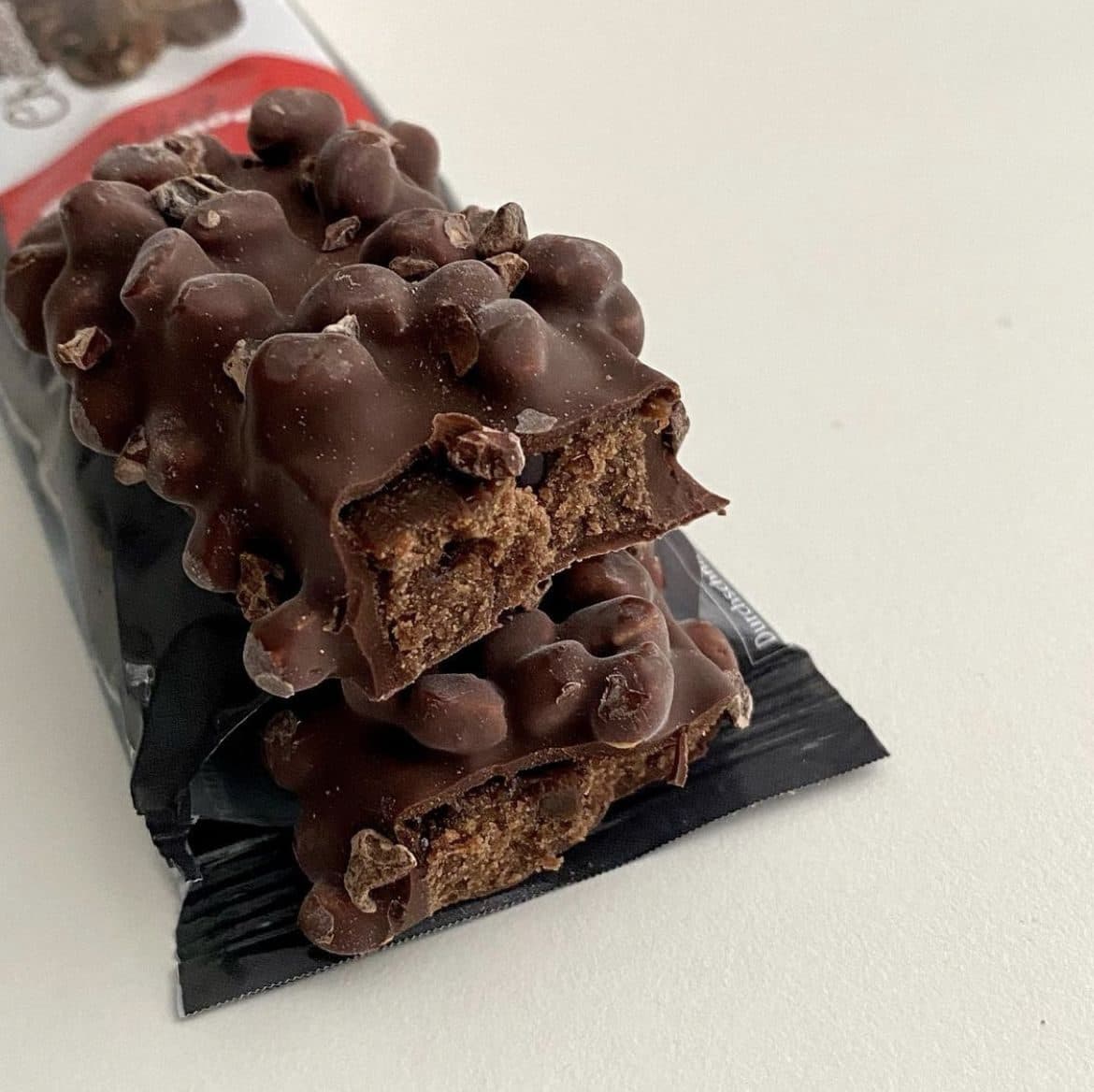 No-bake chocolate protein bars cut on parchment paper