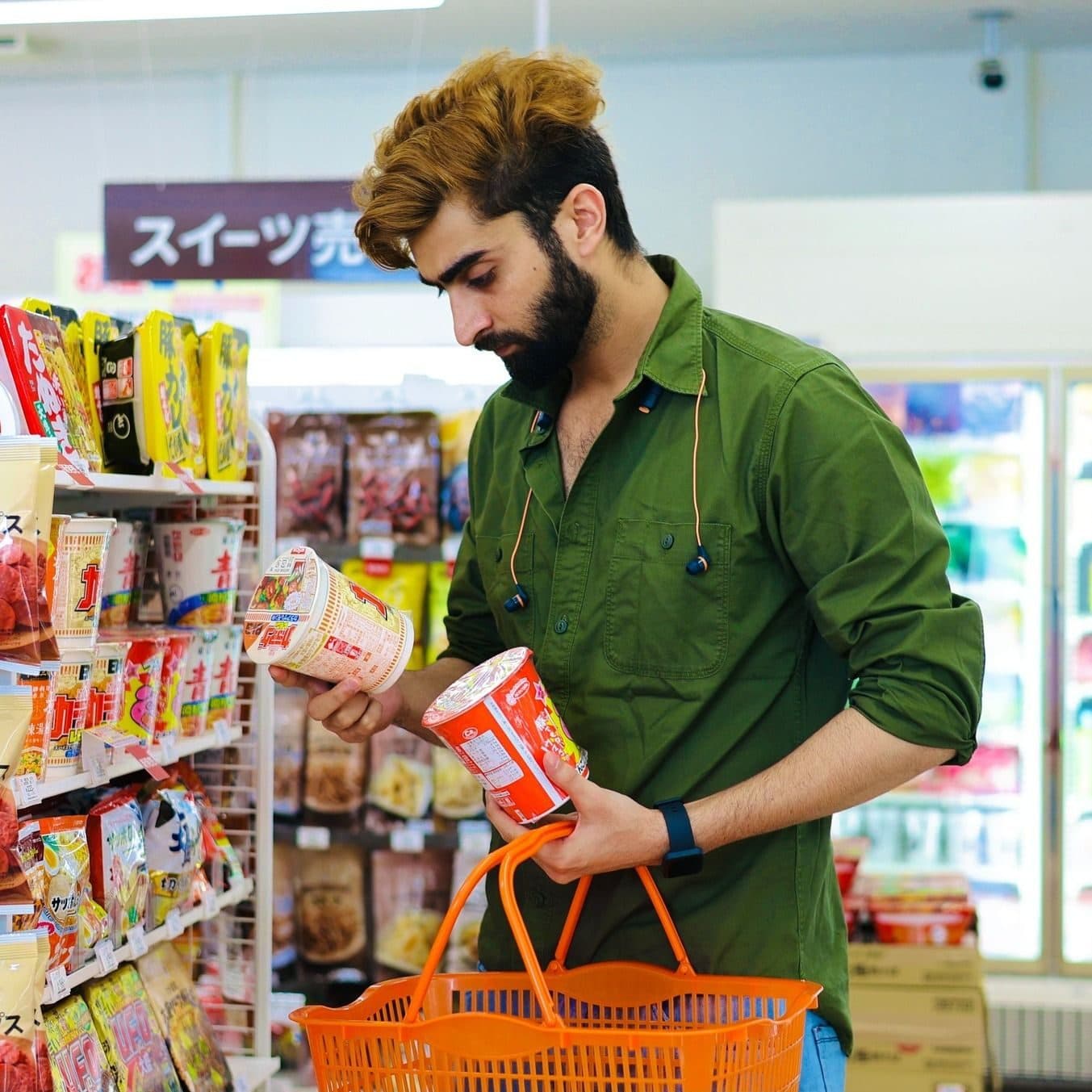 A shopper reading the ingredient label on a packaged product