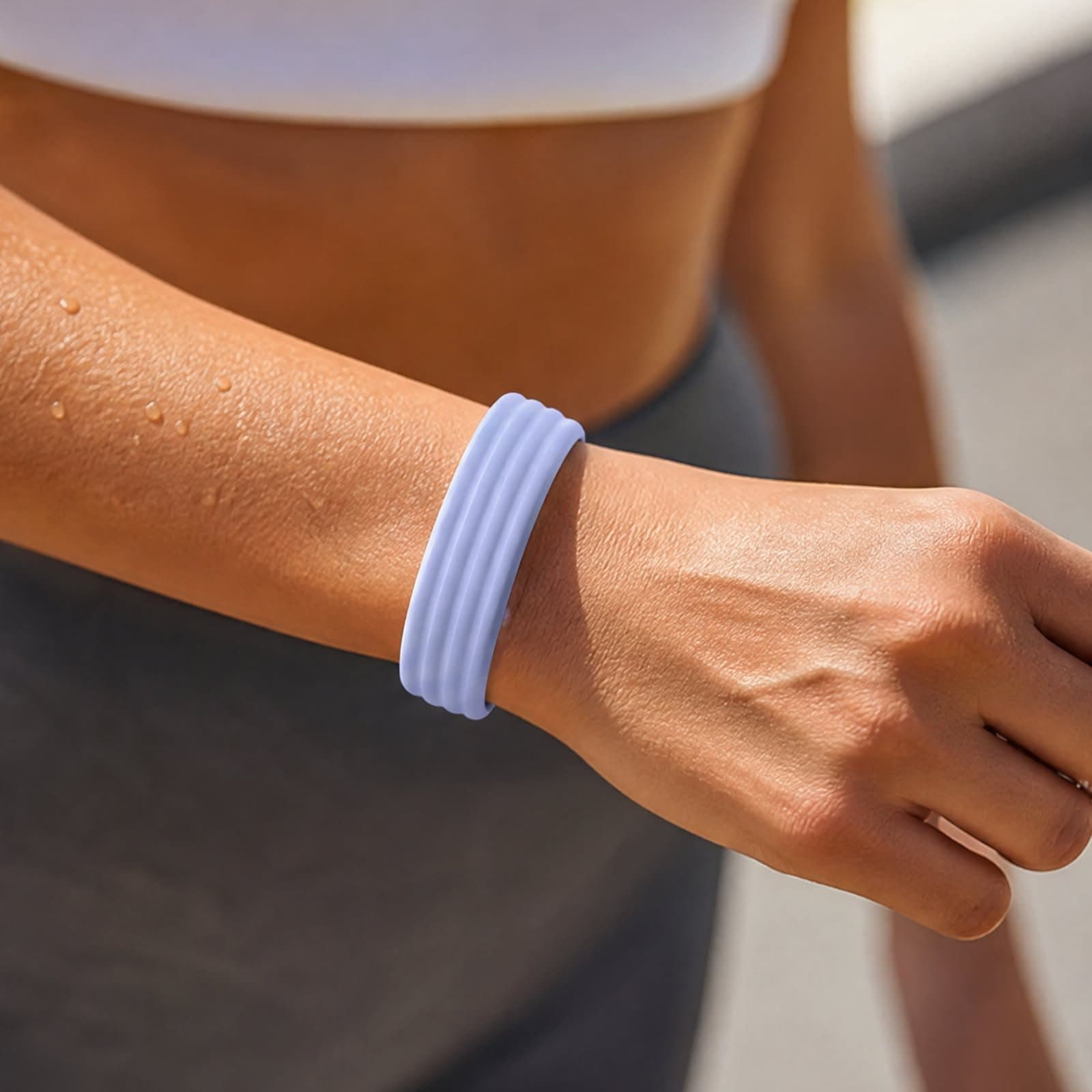 A fitness tracker band on a wrist at the gym